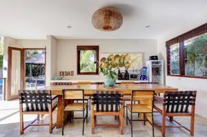 a kitchen with a large wooden table and chairs at Indah Balangan Villa in Jimbaran
