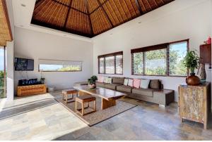 a living room with a couch and a table at Indah Balangan Villa in Jimbaran