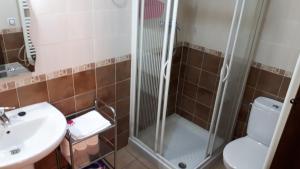 a bathroom with a shower and a sink and a toilet at Casa Tere in Orihuela del Tremedal