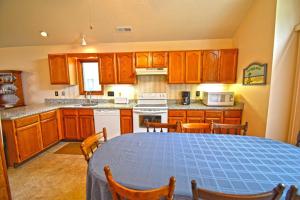 a kitchen with a table with chairs and a blue tiled at Fountain Road Home in Ocean City