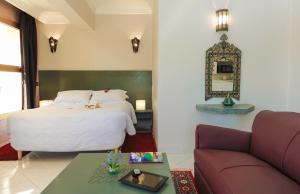pokój hotelowy z łóżkiem i kanapą w obiekcie Appart-Hotel Amina Resort w Marakeszu
