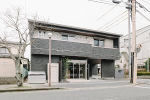 a building on the corner of a street at GRAND BASE Karatsu Ekiminami in Karatsu