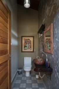 a bathroom with a toilet and a sink at Casa Temporada Castro Alves in Bonito