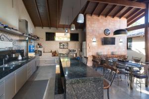a large kitchen with a table and a dining room at Casa Temporada Castro Alves in Bonito
