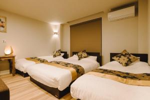 Кровать или кровати в номере GRAND BASE Karatsu Ekiminami