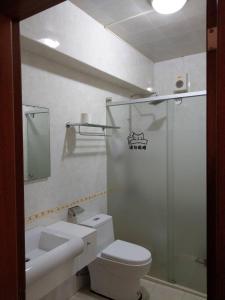 a bathroom with a shower and a toilet and a sink at Hui You Homestay in Magong