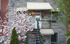 uma casa de tijolos com uma escada que leva a uma porta em Gite Le Sieur de Joliette em Montreal