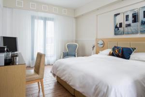 Voodi või voodid majutusasutuse Lagos Mare Hotel toas