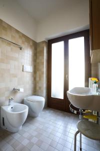 bagno con servizi igienici, bidet e lavandino di Welcome Traveller MERLO NERO APARTMENTS a Garda