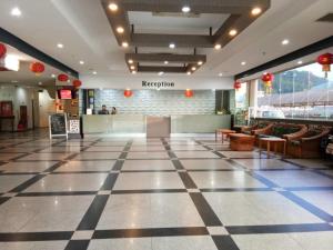 a lobby of a building with a checkered floor at Purnama Hotel in Limbang