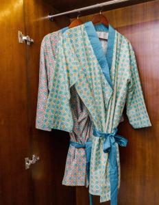 a robe is hanging on a rack on a door at Anja Jimbaran in Jimbaran