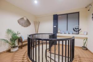 a living room with a spiral staircase and a window at Kent Beach House in Canggu