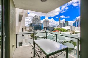 a dining room with a view of the city at Vine Apartments South Brisbane in Brisbane