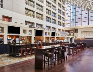 a bar in the middle of a building with bar stools at Hyatt Regency Lexington in Lexington