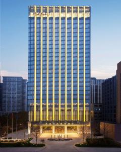 a tall building with a lot of lights on it at Hyatt Regency Jinan in Jinan