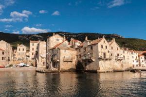 a group of buildings next to a body of water at Bed and Breakfast BLUE in BLUE in Komiža