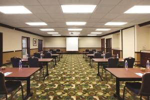 a conference room with tables and chairs and a whiteboard at Hyatt House Denver Tech Center in Centennial