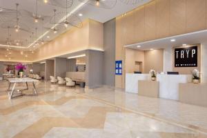 a lobby with a tryp sign on the wall at TRYP by Wyndham Izmit in Kocaeli