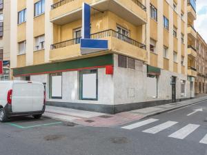 a white van parked in front of a building at Hostal Uría in Salamanca