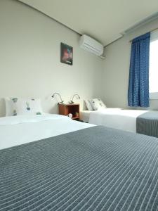 Кровать или кровати в номере Hause Itaewon