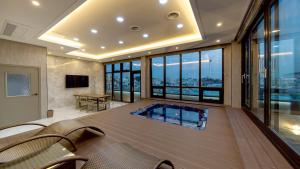 a room with a swimming pool in the middle of a building at GnB Hotel in Busan
