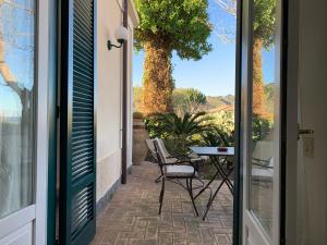 a door leading to a patio with a table and chairs at Villino Eleonora in Parghelia