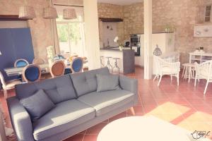 a living room with a couch and a dining room at A CLAIREFONTAINE in Auch