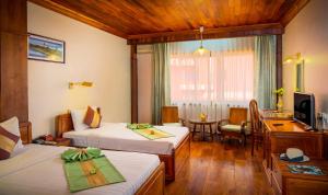 Letto o letti in una camera di Ta Prohm Hotel & Spa