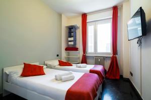 two beds in a room with a window and a tv at Milanocity MICO MIART in Milan