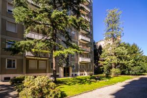 an apartment building with a tree in front of it at Milanocity MICO MIART in Milan