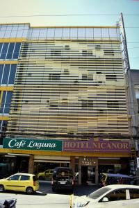a large building with cars parked in front of it at Hotel Nicanor in Dumaguete