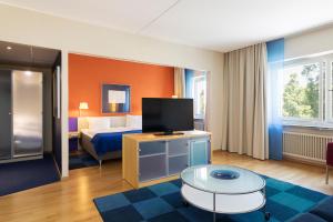 TV a/nebo společenská místnost v ubytování ProfilHotels President