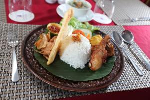 a plate of food with rice on a table at University Club (UC) Hotel UGM in Yogyakarta