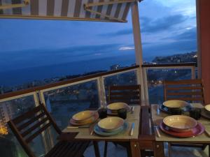 a table on a balcony with a view of the city at Quarto di Luna in Genoa