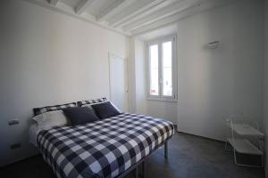 a bedroom with a black and white checkered bed at Piazza Trento 11 in Monza