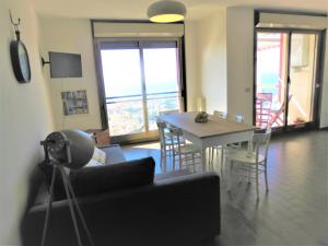 a living room with a couch and a table with chairs at Quarto di Luna in Genoa
