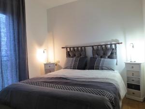 a bedroom with a large bed with two night stands at Quarto di Luna in Genoa