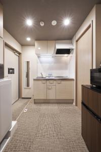 an empty room with a kitchen in a building at Stay SAKURA Kyoto Kiyomizu Gojo in Kyoto