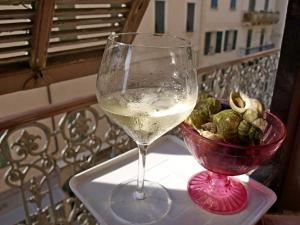 a glass of wine and a bowl of food on a table at Matteotti in Sanremo