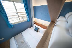 Postel nebo postele na pokoji v ubytování D.C. Inn