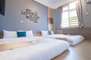 Postel nebo postele na pokoji v ubytování D.C. Inn