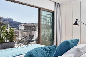 1 dormitorio con cama y ventana grande en MONO Lofts, en Atenas