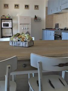 a kitchen with a wooden table with two chairs at Quarto di Luna in Genoa