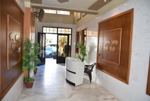 a hallway with a door and a bench and plants at Wellness Home in Tangier