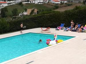 a group of people playing in a swimming pool at B&B O Pescador in Nazaré