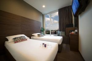 Value Hotel Thomson客房内的一张或多张床位