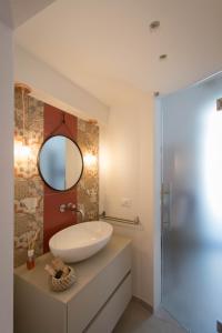 a bathroom with a sink and a mirror at Little House in Siracusa