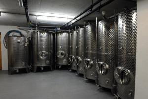 a row of metal tanks in a wine cellar at Ferienweingut Wolfgang Adamy in Kinheim