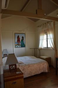 a bedroom with a large bed and a window at Les Rouges Gorges du Domaine du Moulin 14 in Étables