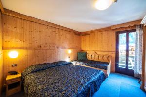 Letto o letti in una camera di Hotel Cime D'Oro